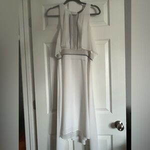 BCBG white dress. Knee length. Longer on the sides, opens in the back.